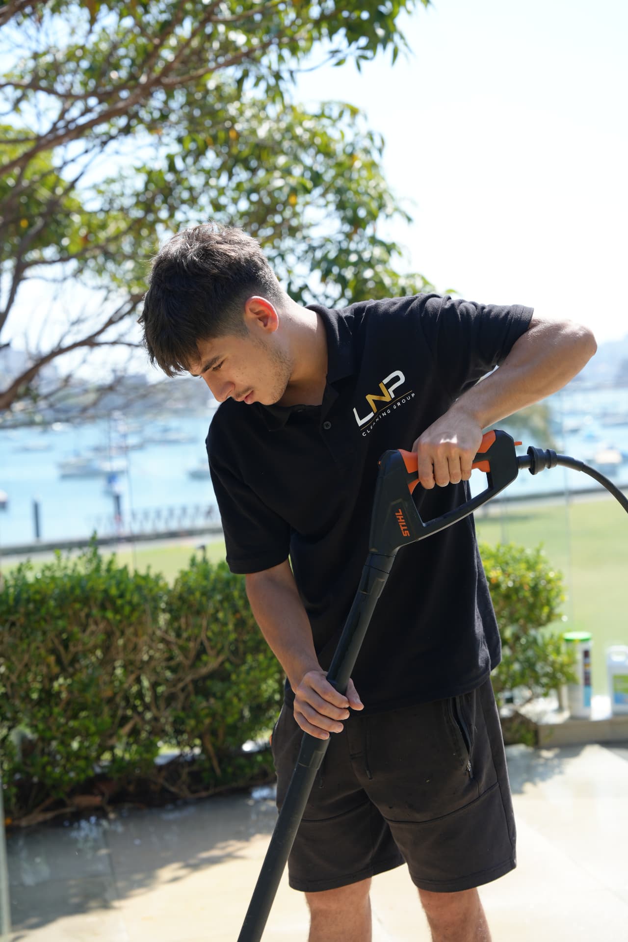 Nicholas from LNP Cleaning Group pressure washing an outdoor area